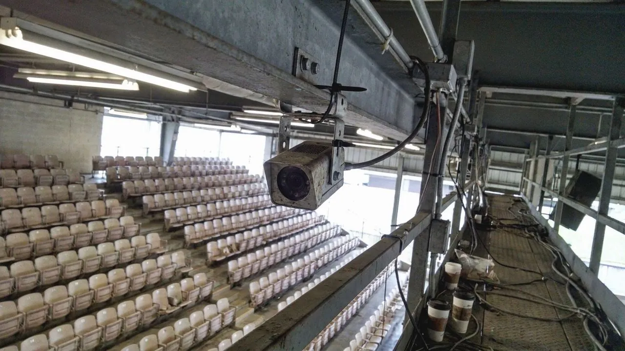 Empty stadium seating in rows.